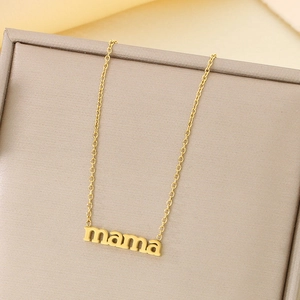 Detailed view of 18K gold plated mama letter necklace inside a beige jewelry box
