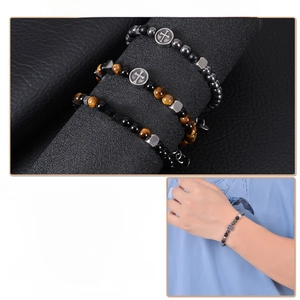 Detail of natural stone cross bracelets for men featuring hematite and tiger eye beads