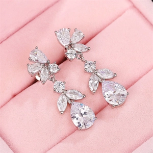 Close-up of wisteria floral silver earrings with pear-cut crystals in pink velvet box