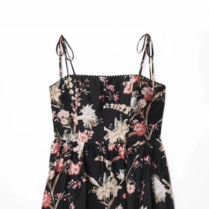Sleeveless floral linen blend dress in black with delicate spaghetti straps and pattern