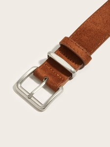 Detail view of brown suede waist belt with a matte silver metal pin buckle