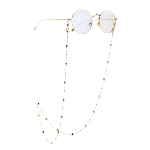 Gold eyewear chain with heart charms and white pearls on retro round metal glasses