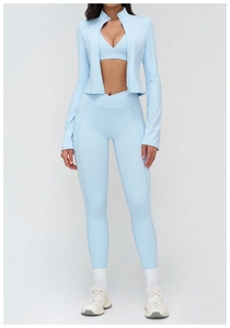 Detailed view of light blue three-piece yoga set with stand-up collar zip jacket and leggings