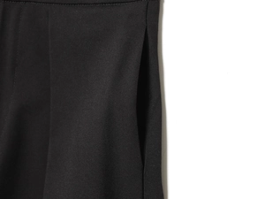 Detailed close-up of side pockets and stitching on black high waist balloon pants