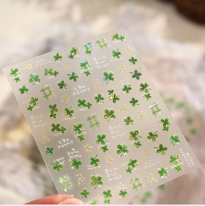 Detailed view of M-1386 nail stickers featuring green clovers and golden stars designs