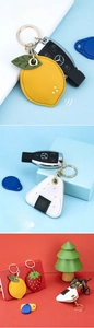 Close-up of cute cartoon PU leather keychains with fruit shapes and gold metal clips
