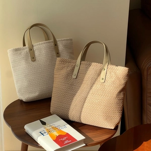 Retro canvas tote bags with wheat pattern and leather handles on a wooden table