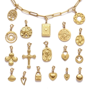 Gold stainless steel necklace with tree of life, cross, and heart charms in grid layout