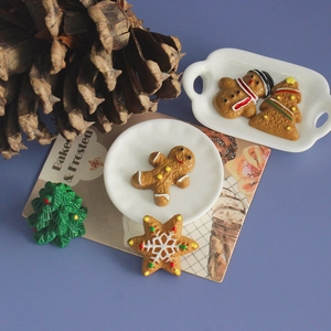 Christmas gingerbread man and tree resin miniatures for DIY fridge magnets on a white plate