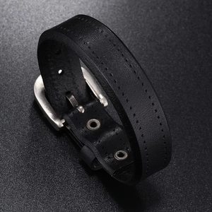Detailed close-up of premium black leather bracelet featuring double stitching and metal buckle