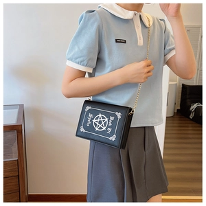 Detailed view of the Book Of Spells gothic crossbody bag with metallic chain strap