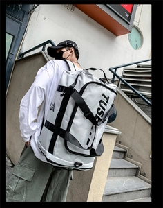 Close-up of a large grey Oxford fabric backpack featuring TUSE logo and reinforced straps