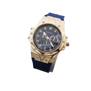 Octagonal gold case sports quartz watch with blue silicone strap and three-eye dial