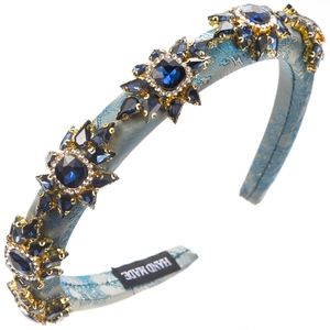Detailed view of hand made label on baroque headband with blue rhinestones and gems