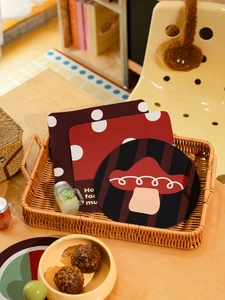 Detail of mushroom diatom mud coasters in a woven basket on a wooden table surface