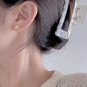 Close-up of minimalist gold 925 silver coffee bean earrings worn for a stylish look