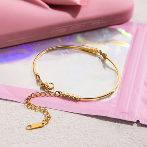 Classic 18K gold plated stainless steel bangle with sparkling white diamonds and chain