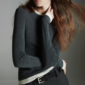 Detail of wool blend slim fit sweater with contrast trim on neck and cuffs
