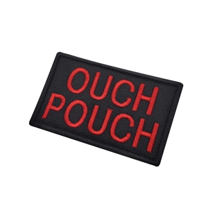 Tactical OUCH POUCH embroidered patch with red letters on black background and hook loop