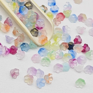 Macro detail of mixed colorful lily of the valley glass flower beads for DIY jewelry