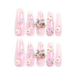Extra long pink glitter press-on nails with 3D floral and butterfly rhinestone accents