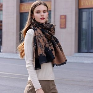 Stylish brown and black cashmere-like scarf with abstract patterns and tassel fringe