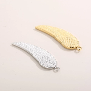 Detail view of gold and silver stainless steel angel wing pendants for DIY jewelry