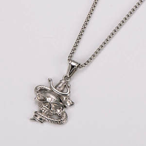 Detail shot of stainless steel necklace featuring a skull and snake pendant with box chain
