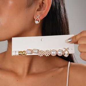 Detail of 12-piece earring set featuring faux pearls, rhinestones, and gold geometric designs