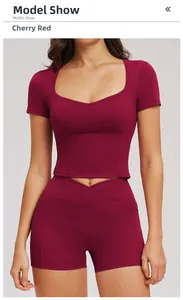 Detail of cherry red yoga set featuring cross-waisted shorts with side pockets