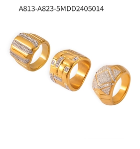 Detailed view of three gold-plated titanium steel rings with geometric diamond patterns