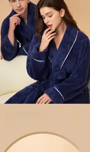 Detail of dark blue thick flannel bathrobe featuring soft texture and white piping trim