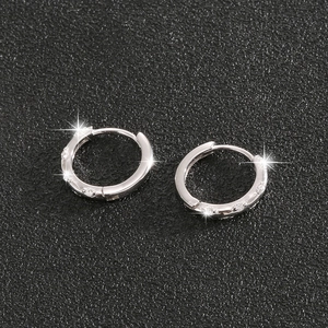 Macro shot of silver S925 sterling silver hoop earrings with sparkly pave setting