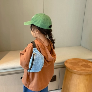 Kids blue denim waist bag with adjustable black strap for casual everyday wear