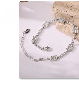 Detailed view of silver stainless steel bracelet with square cubic zirconia inlay