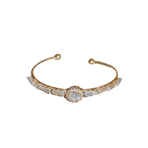 Luxurious gold-plated open bangle with central round zircon cluster and rectangular crystals