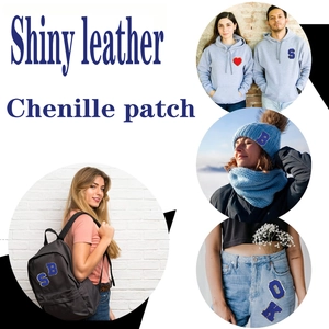 Application of blue chenille letter patches with shiny leather edges on clothes and bags