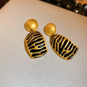 Vintage gold matte sphere earrings with black zebra pattern charms on leather