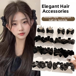 Detail view of 12-piece black bow hair clip set with pearls and rhinestones on cards