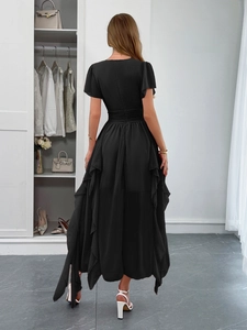 Detail of black short sleeve dress featuring ruffle hem and high-low silhouette back view