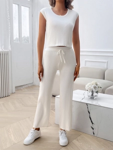 Detailed texture of white ribbed knit sleeveless top and wide-leg drawstring trousers