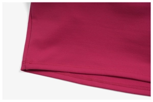Close-up of the double-needle coverstitch hem on dark pink athletic yoga t-shirt