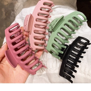 Set of four large matte shark hair clips in pink, green, and black for thick hair styling