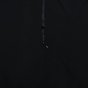 Detail shot of the hidden zipper design and high-quality fabric texture on the black dress