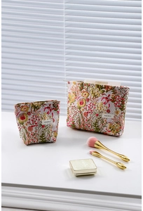 Close-up of floral jacquard makeup bags with embroidery details and logo label