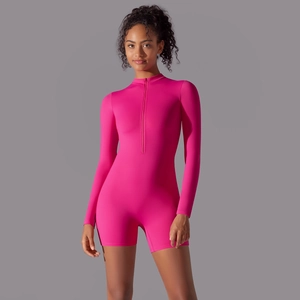 Close-up of bright pink long sleeve jumpsuit with half-zipper collar and elastic fabric