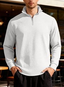 Detailed close-up of white waffle knit fabric texture on men's half-zip sweatshirt