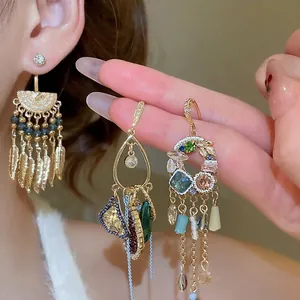French vintage tassel earrings with sparkling crystals and golden feather pendants