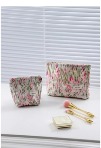 Detail of floral tapestry makeup bags with gold zippers and H&R BAG labels