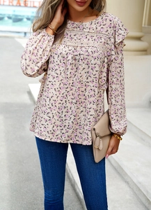 Detail view of floral long sleeve blouse featuring lace patchwork and ruffled cuffs